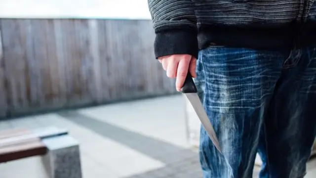 Person carrying knife