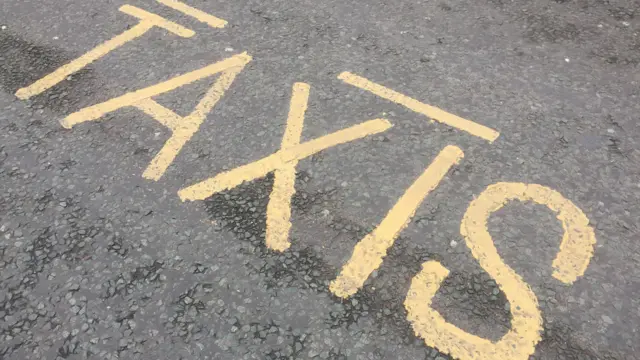 Taxi sign on road