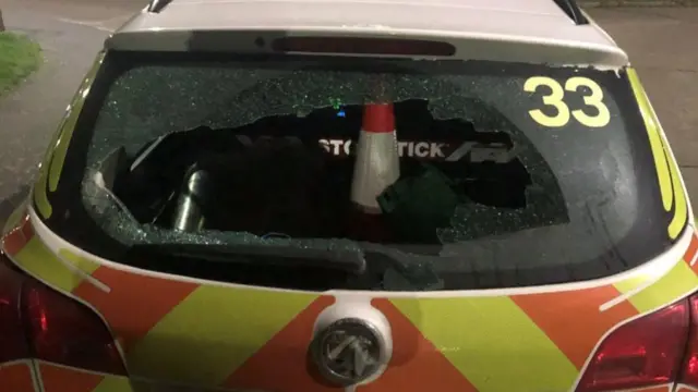 Smashed police car window