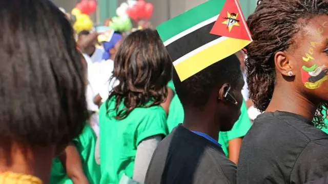 Mozambicans displaying the national flag