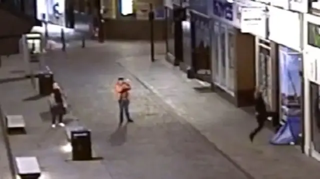 CCTV footage showing a man diving feet-first on top of the tent