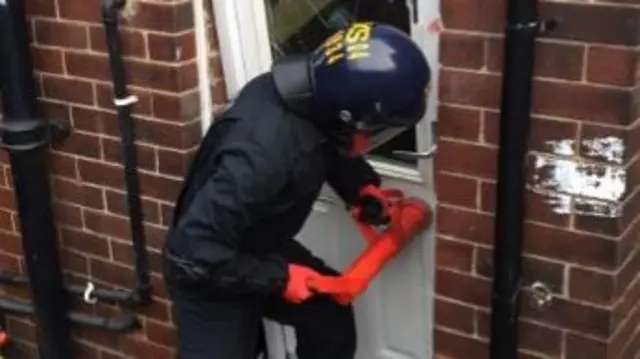 Police breaking down a door