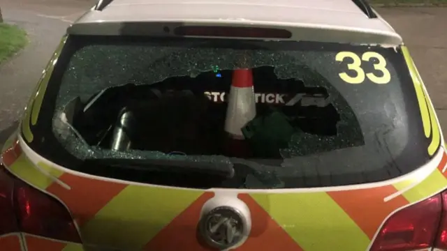 Smashed window on police car