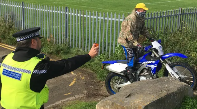 Police officer using DNA spray
