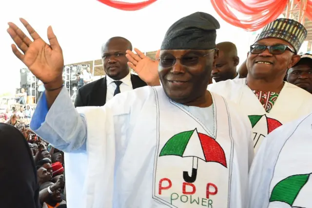 Atiku Abubakar (front C), followed by Vice Presidential candiate Peter Obi (rear R), waves as he arrives for the launching of their campaign during a political rally in Ilorin, northcentral Nigeria, on December 5, 2018