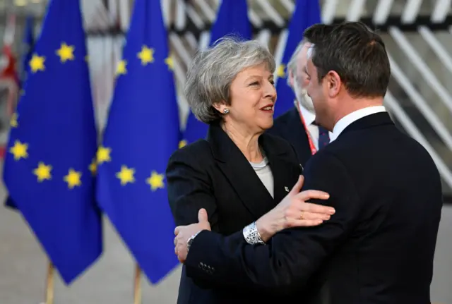 Luxembourg's Prime Minister Xavier Bettel hugs Mrs May