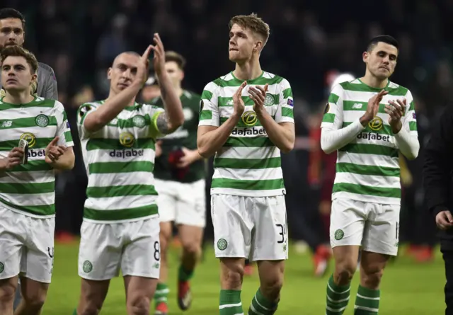 Celtic players salute the fans at full time