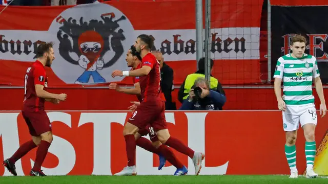 Munas Dabbur (left) celebrates scoring against Celtic