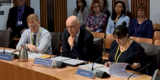 Dr Patrycja Kupiec and Audrey Opdycke-Barnes listen intently to the deputy first minister