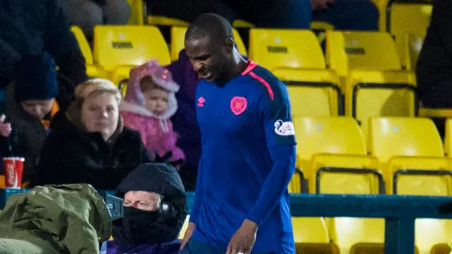 Hearts defender Clevid Dikimona leaves the pitch in pain