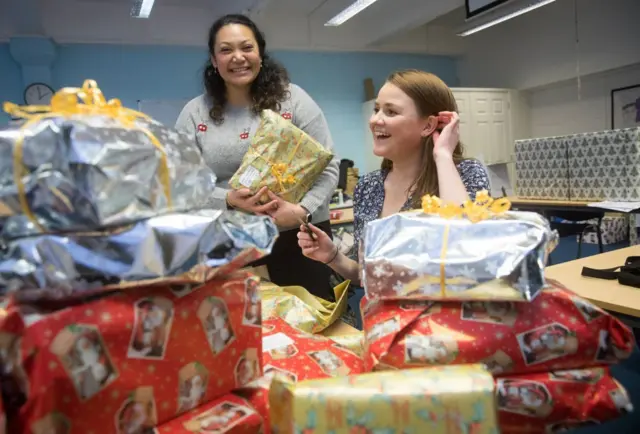 People wrapping presents