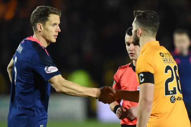 Hearts captain Christophe Berra and Livi counterpart Craig Halkett shake hands