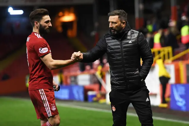 Aberdeen's Graeme Shinnie and Derek McInnes shake hands