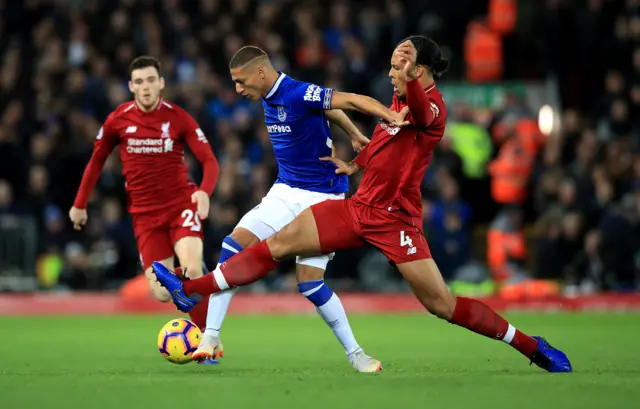 Richarlison is tackled by Virgil van Dijk