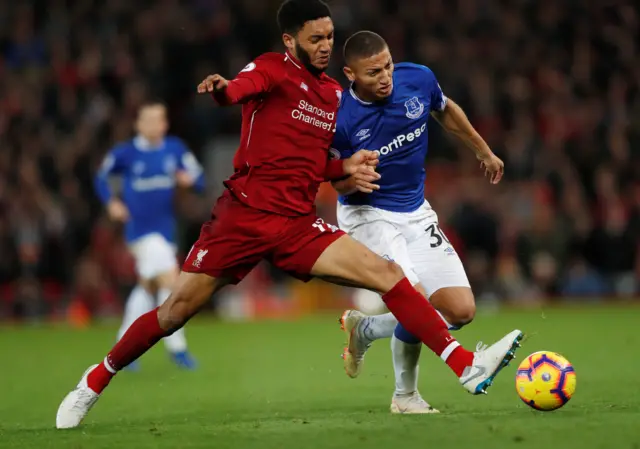 Joe Gomez and Richarlison compete for the ball