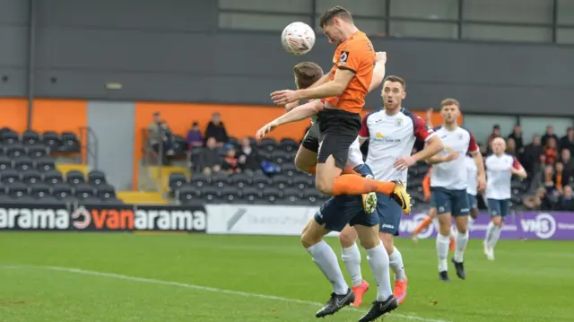 Dan Sparkes scores with a header for Barnet