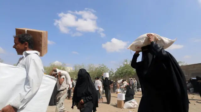 People carrying aid