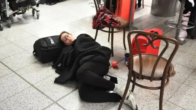 Passenger sleeping on floor of Gatwick Airport