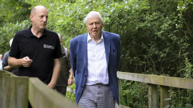 Sir David Attenborough being shown around the nature reserve