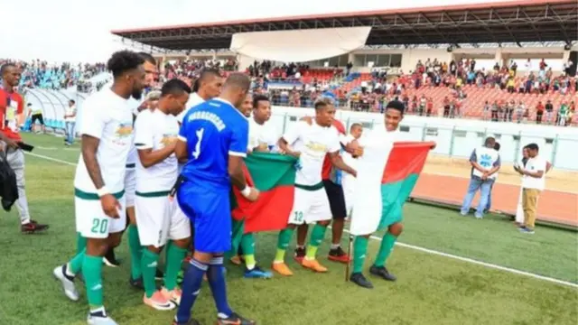 Madagascar team members celebrate on the pitch