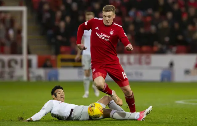 Aberdeen’s Lewis Ferguson takes on Hearts’ Sean Clare