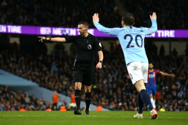 Andre Marriner awards a penalty