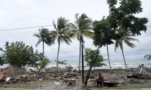 A man looks at destroyed homes in Anyer, Indonesia. Photo: 23 December 2018