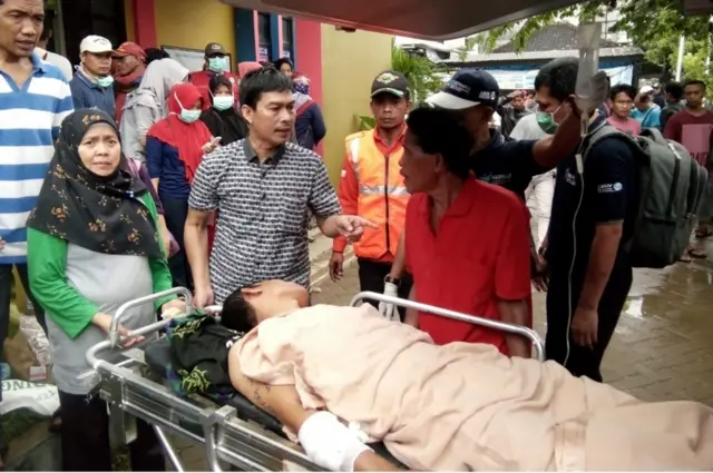 An injured man is taken to hospital in Carita, Indonesia. Photo: 23 December 2018