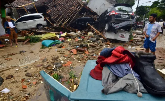 Residents inspect damaged buidlings in Carita