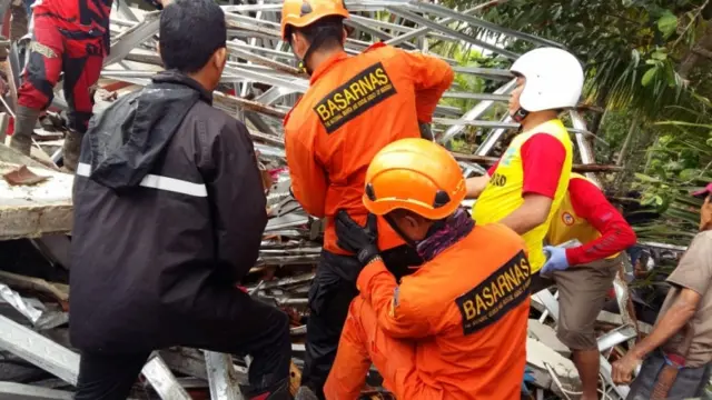 Rescue team members attempting to clear debris after the tsunami hit at Banten province