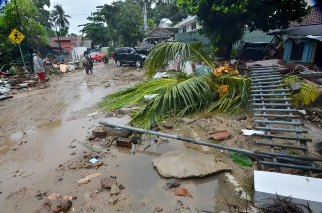 Debris is seen on a road in Carita