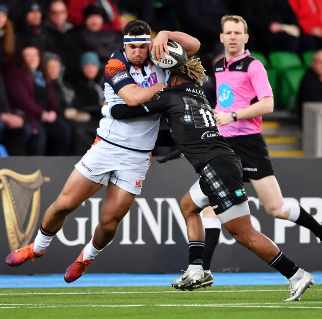 Edinburgh's Stuart McInally is tackled by Niko Matawalu