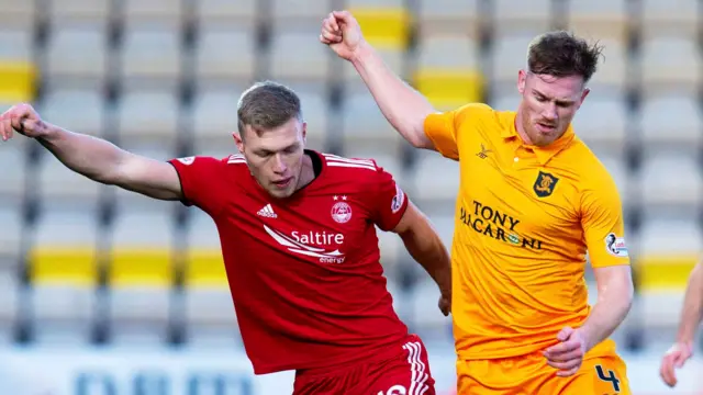 Aberdeen's Sam Cosgrove competes with Livingston's Alan Lithgow