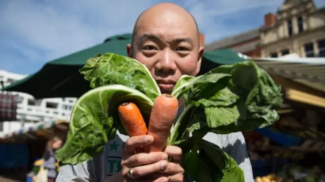 Man holding carrots