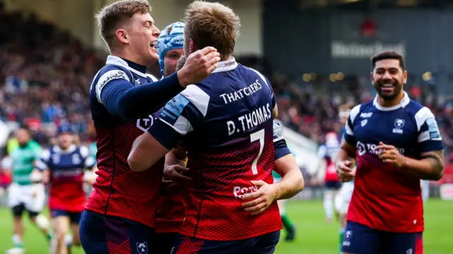 Harry Randall of Bristol Bears celebrates with Tom Pincus and Dan Thomas after he scores the opening try of the game