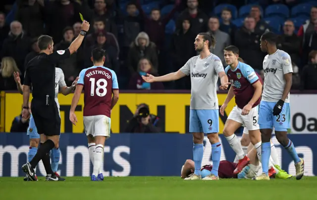 Andy Carroll is shown a yellow card