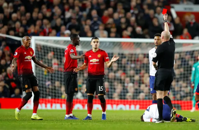 Manchester United"s Eric Bailly is shown a red card