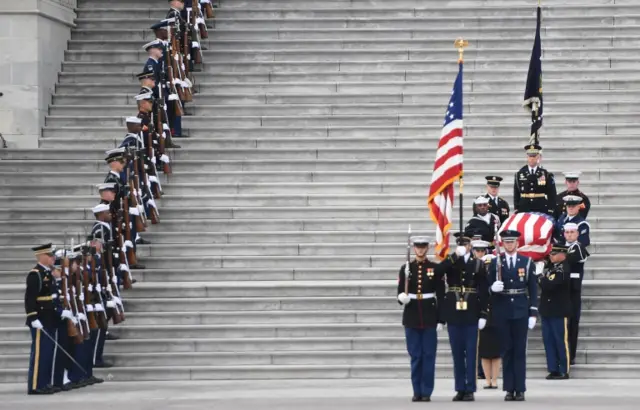 The casket with the remains of former US President George H.W. Bush departs the US Capitol during a State Funeral in Washington, DC