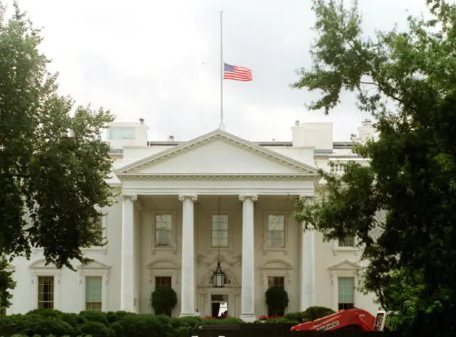 The US flag over the White House flies at half-staff