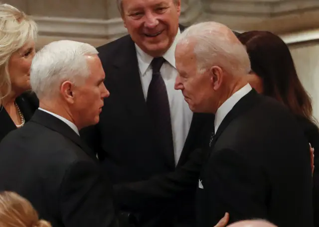 US Vice-President Mike Pence (L) greets Former United States Vice-President Joe Biden