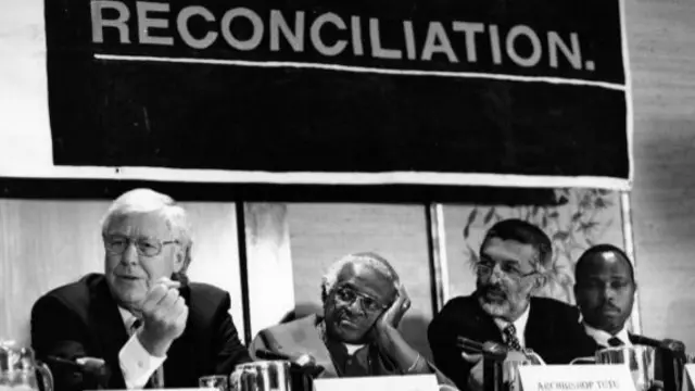 Alex Boraine (L) and Desmond Tutu (C) at a TRC hearing in 1997