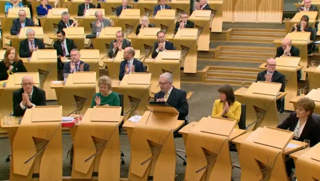 SNP benches applauding