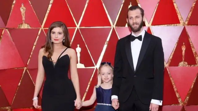 Six-year-old Maisie Sly on the red carpet at the Oscars, with the film's writer and director