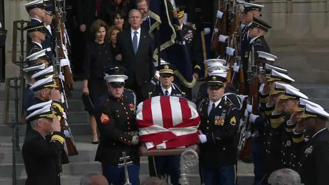 Bush family follows casket