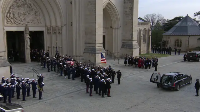 Body bearers and ceremonial troops escort casket