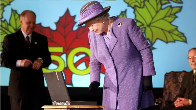 Queen Elizabeth looking at a laptop