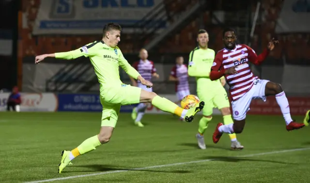 Oli Shaw hooks the ball home for Hibs