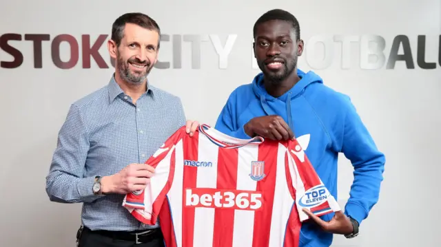 Badou Ndiaye (right) with Stoke City's chief executive Tony Scholes