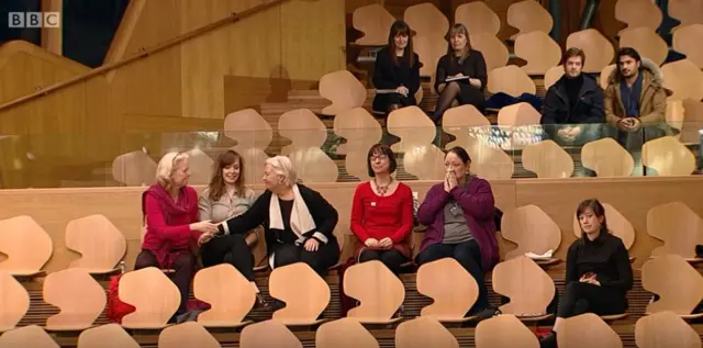 Dr Marsha Scott, centre with the scarf fellow women's organisation representatives