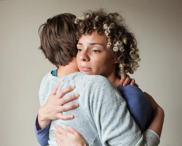 Child hugging parent